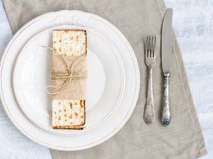 matzo cracker on plate with knife and fork