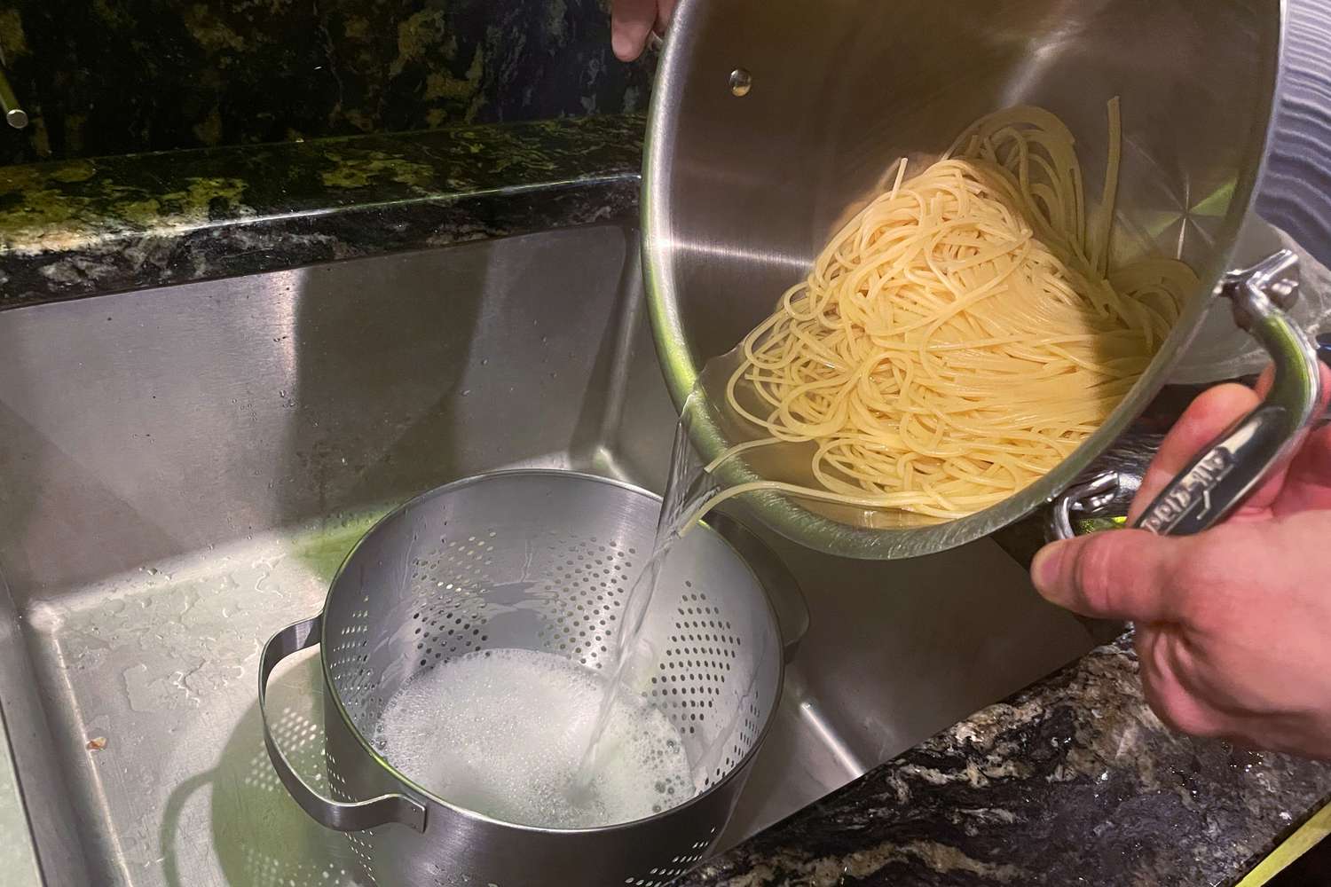 Straining cooked pasta out of the All-Clad D3 12-quart stockpot