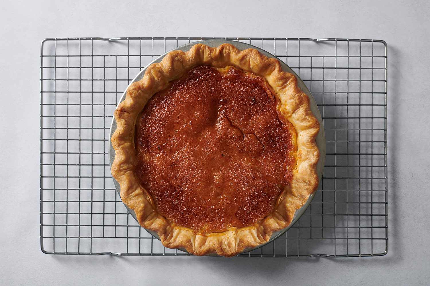 honey pie cooling on a wire rack