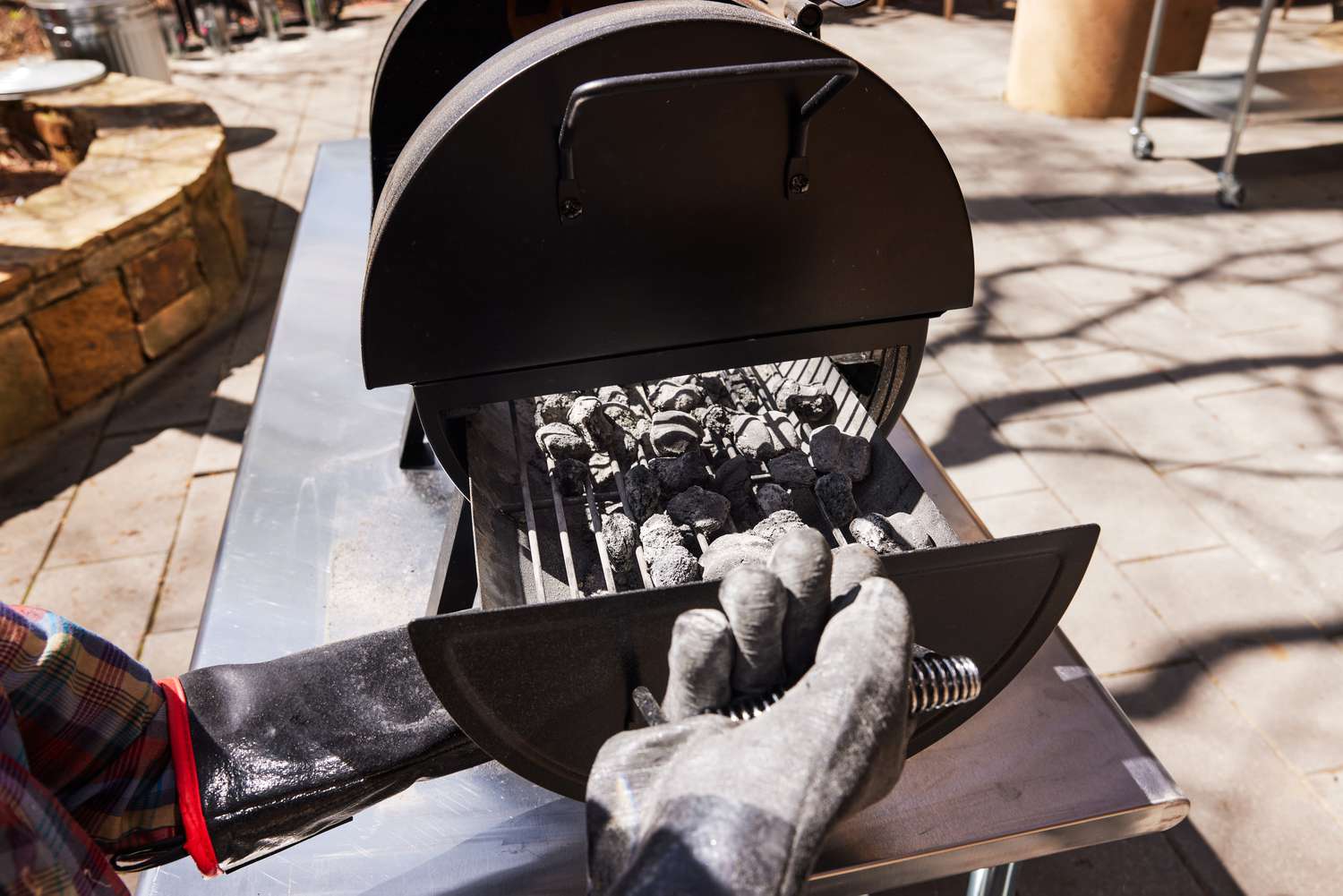Adjusting the charcoal in the Dyna Glo Tabletop Grill