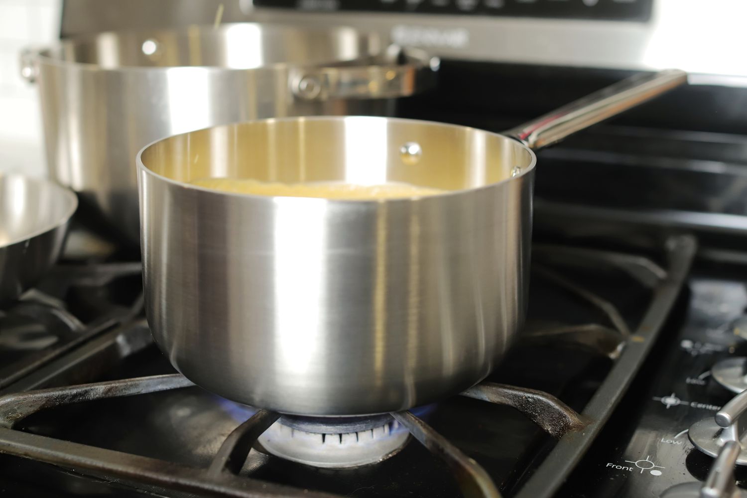 Stainless steel saucepan on a gas cooktop