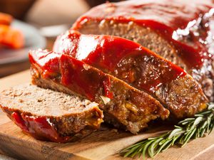 Meatloaf sliced with sauce drizzled on top