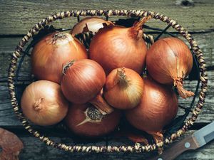 High Angle View Of Onions In Basket On Table