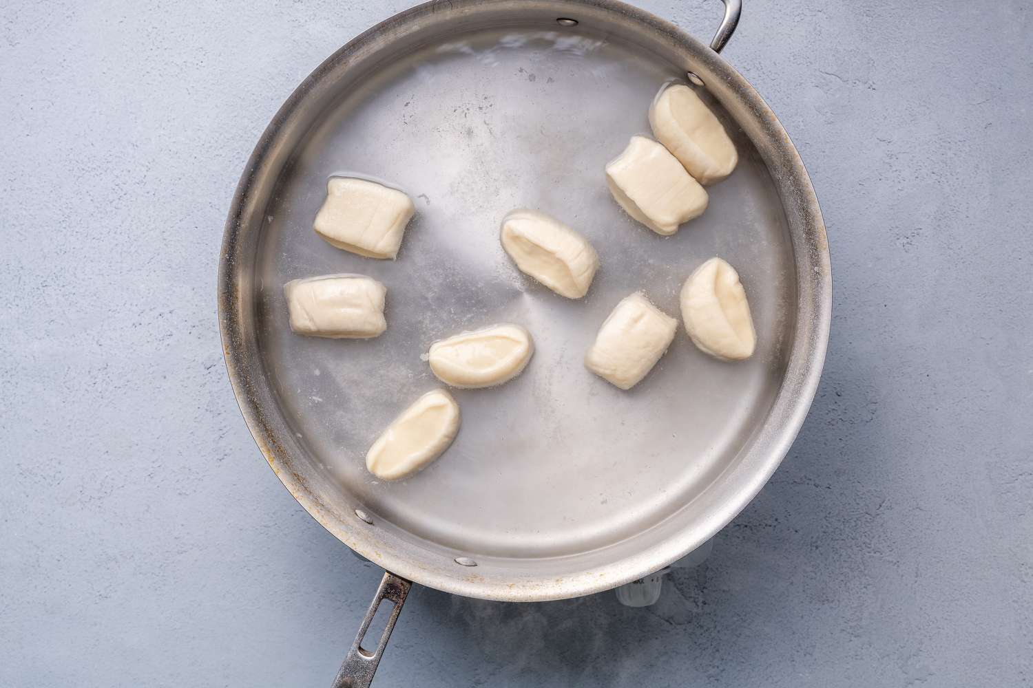 Pieces of dough in the pot of boiling water