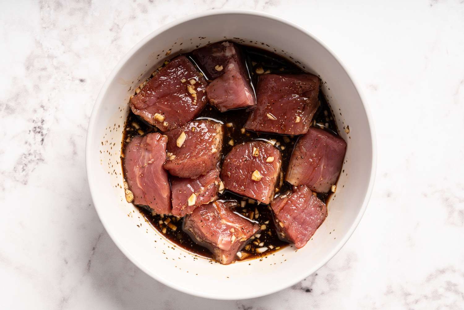 Pork cubes in marinade in a bowl