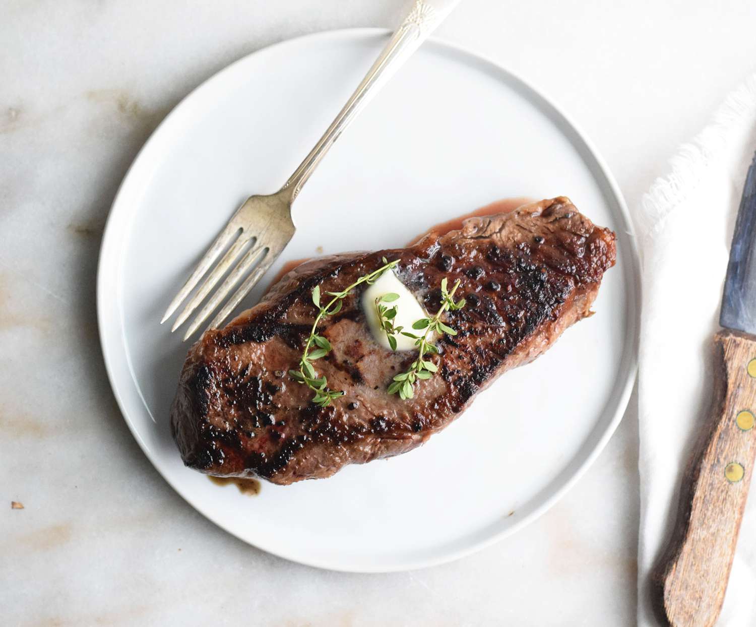 Sous vide steak with a pat of butter and thyme