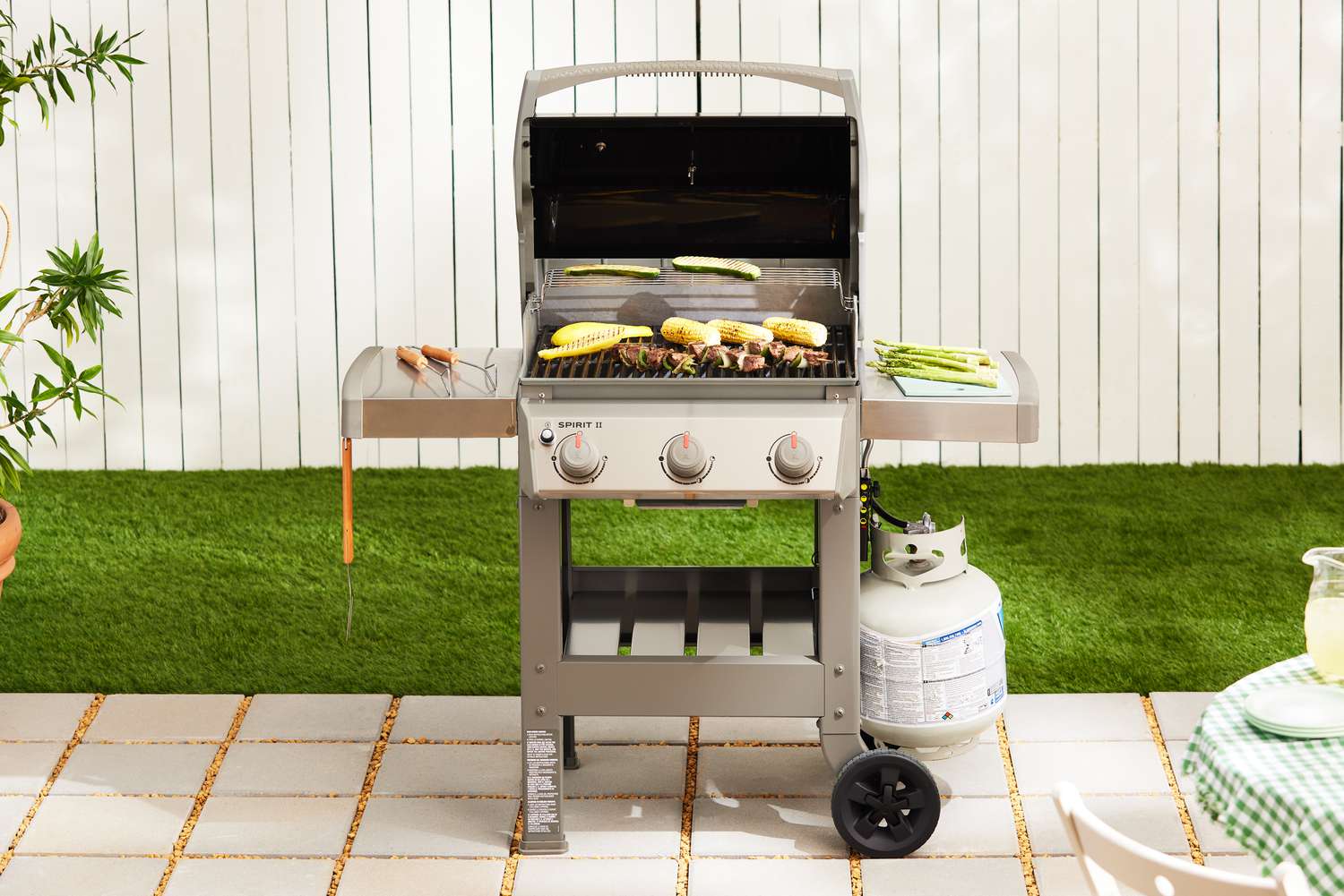 Weber Spirit II E-310 3-Burner Gas Grill displayed on pavers