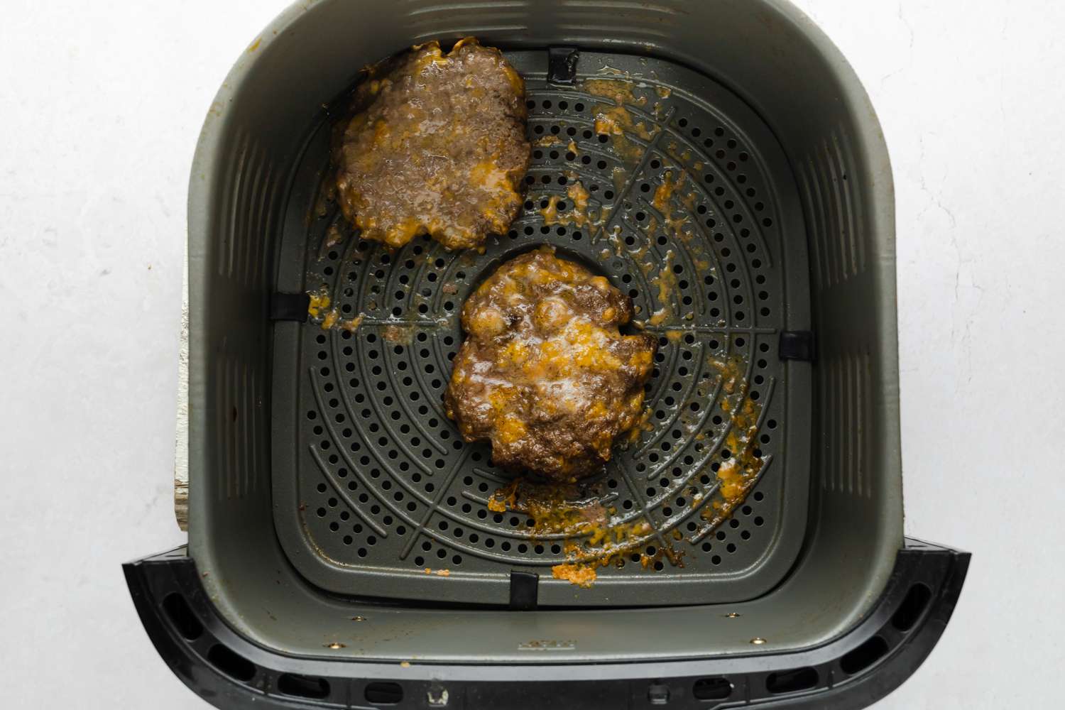 cooked burger patties in an air fryer 