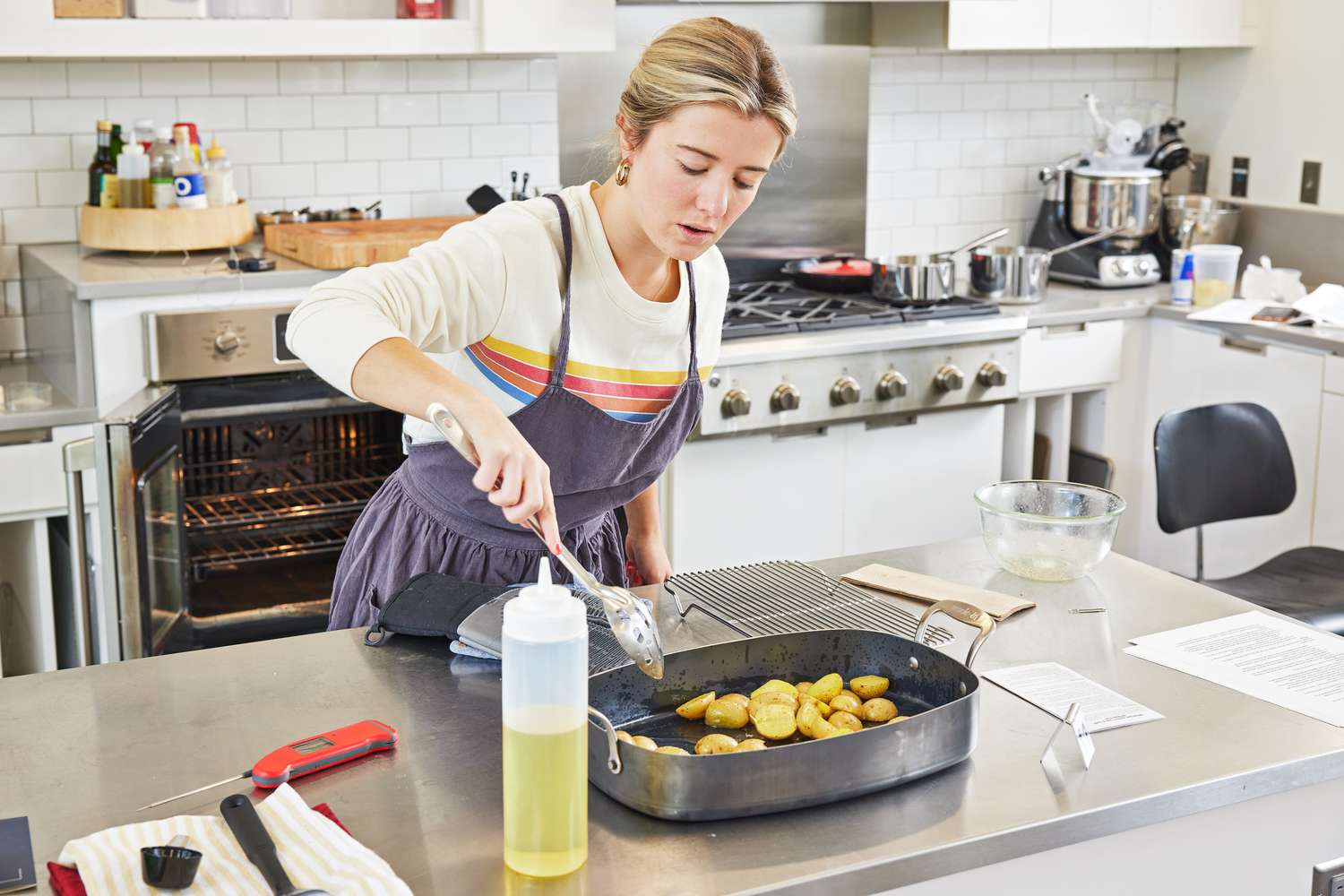 Person scooping potatoes out of the Made In Roasting Pan