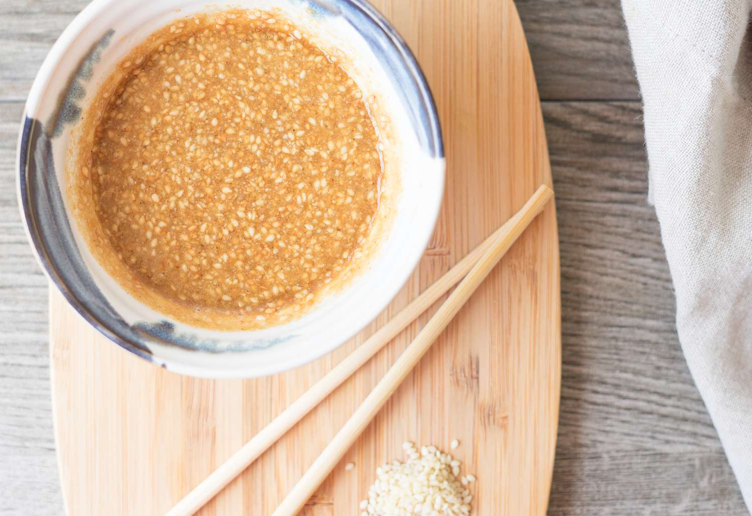 Japanese sesame seed dressing in a bowl with chopsticks alongside