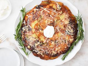 finished potato galette on a platter with rosemary