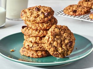 A stack of lactation cookies on a plate, served with a glass of milk