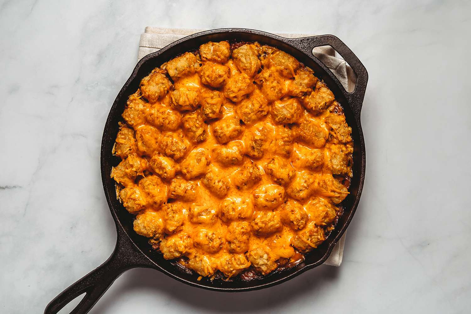 Cheese on top of the Cheeseburger Casserole in a cast iron skillet 