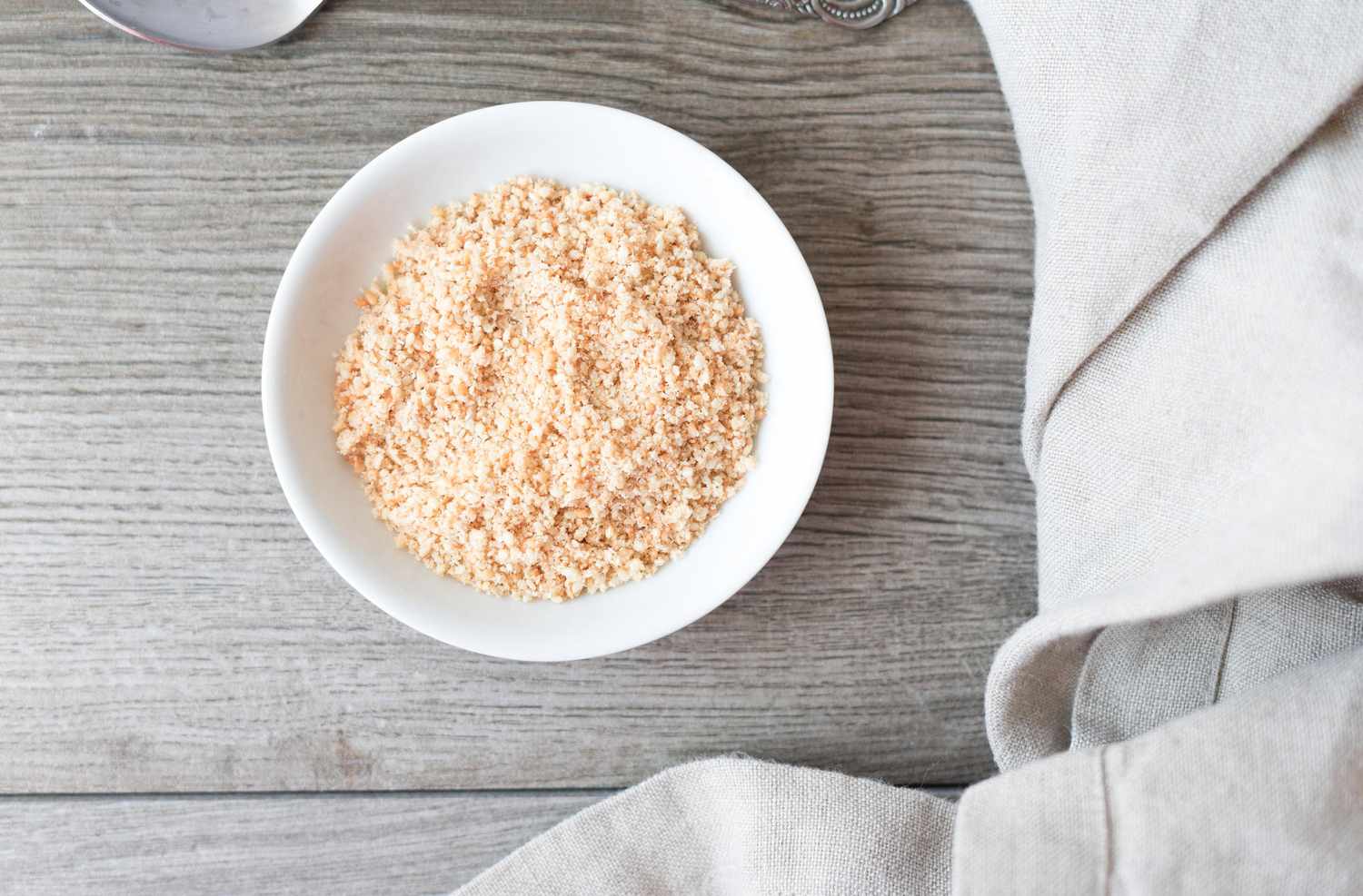 Ground and toasted sesame seeds in a white bowl