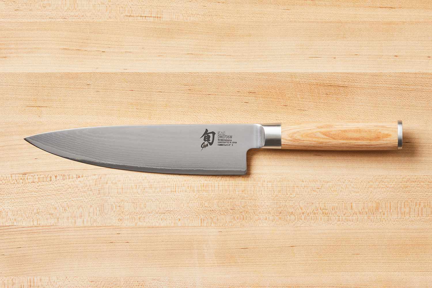 Shun Classic Chef's 8-Inch on a wooden cutting board