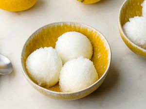 Lemon Italian ice scooped into yellow bowls