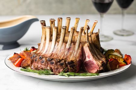 Classic Crown of Lamb Recipe and Gravy on a platter 