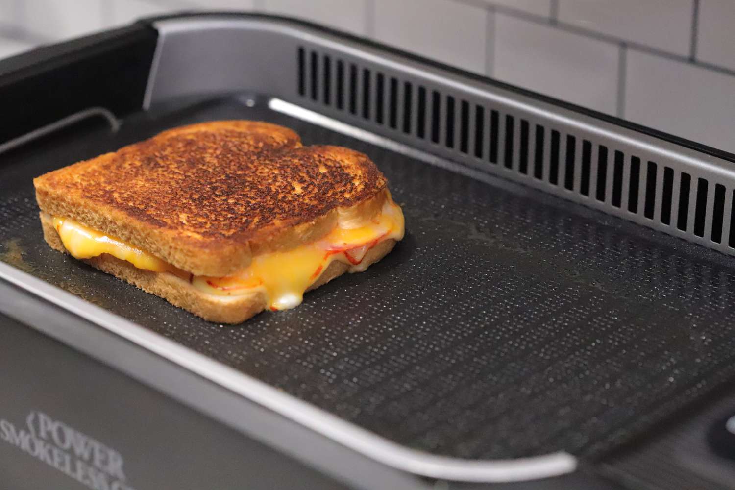 Grilled cheese sandwich cooking on the Power XL Smokeless Indoor Grill 