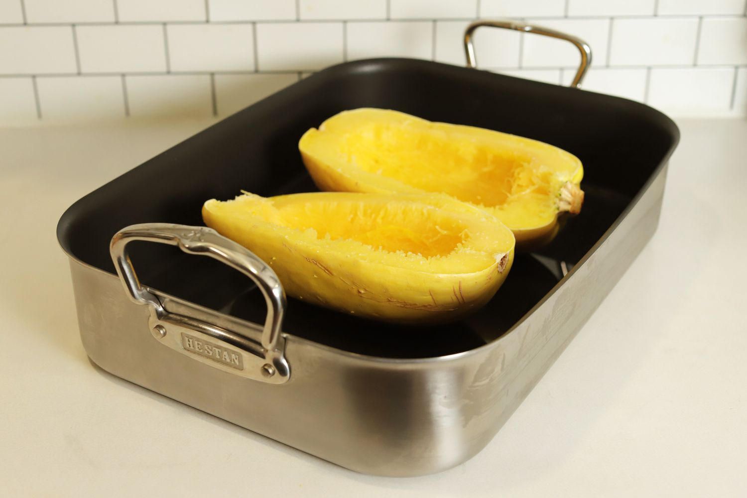 Halved spaghetti squash in the Hestan Stainless Steel Nonstick Roaster