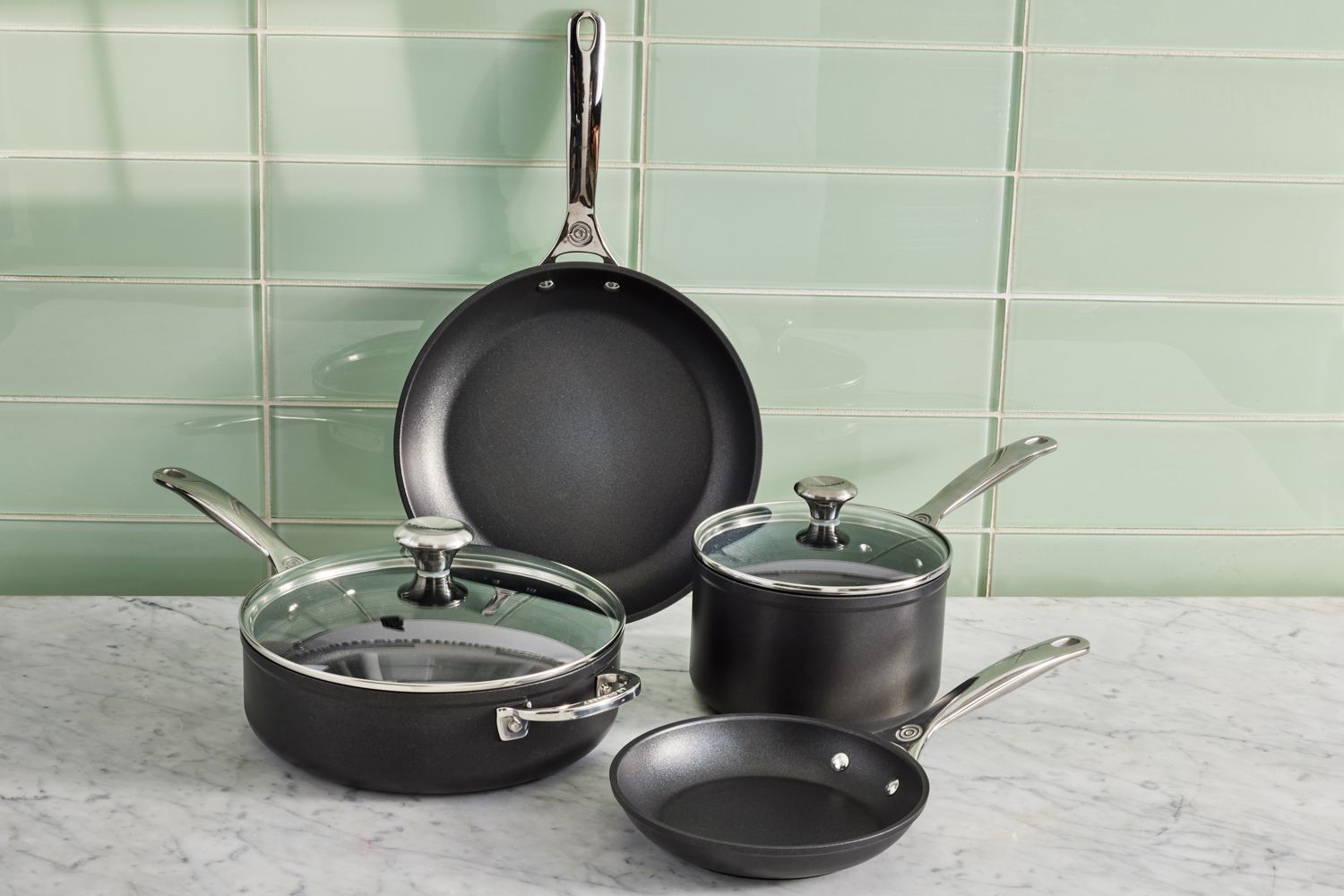 Le Creuset Toughened Nonstick Pro 6-Piece Cookware Set displayed on a marble counter