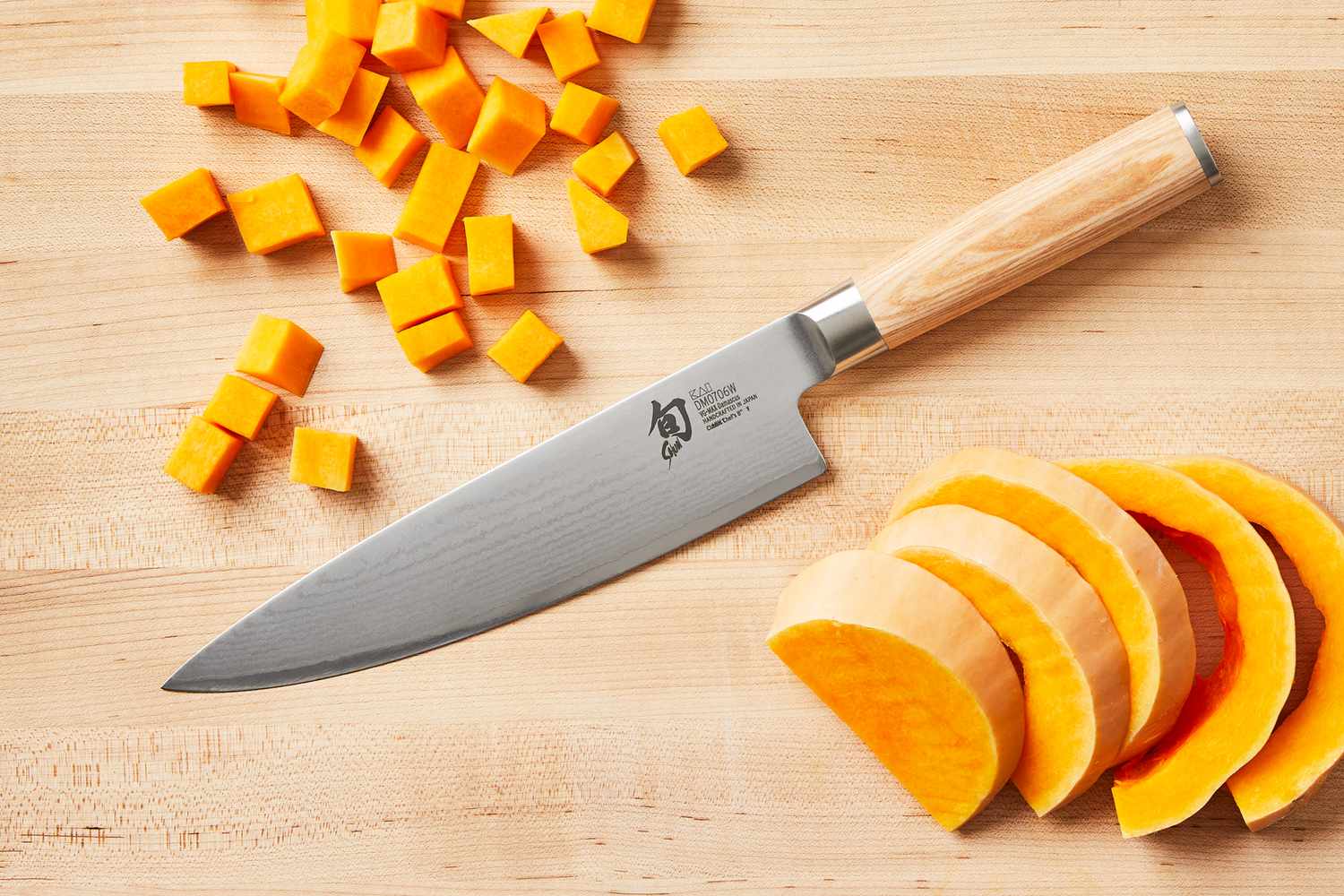 Shun Classic Chef’s 8-Inch knife on a wooden cutting board with sliced and diced butternut squash