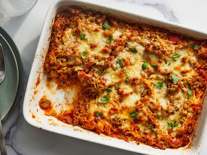 A spaghetti squash and ground beef casserole with a serving removed