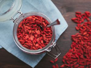 Glass container with goji berries and spoon