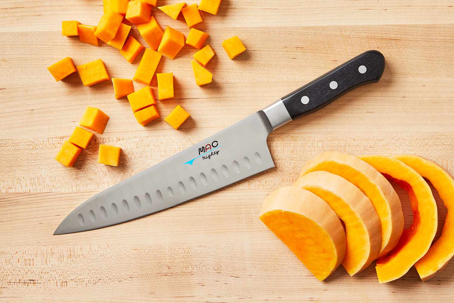 Mac Knife 8-Inch Hollow Edge Chef's Knife on a wooden cutting board with sliced and diced butternut squash