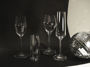 A variety of champagne glasses near a disco ball