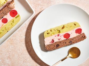 A slice of spumoni ice cream on a plate