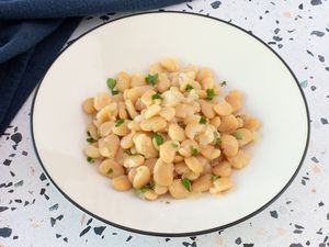 Lima beans in a white bowl with parsley