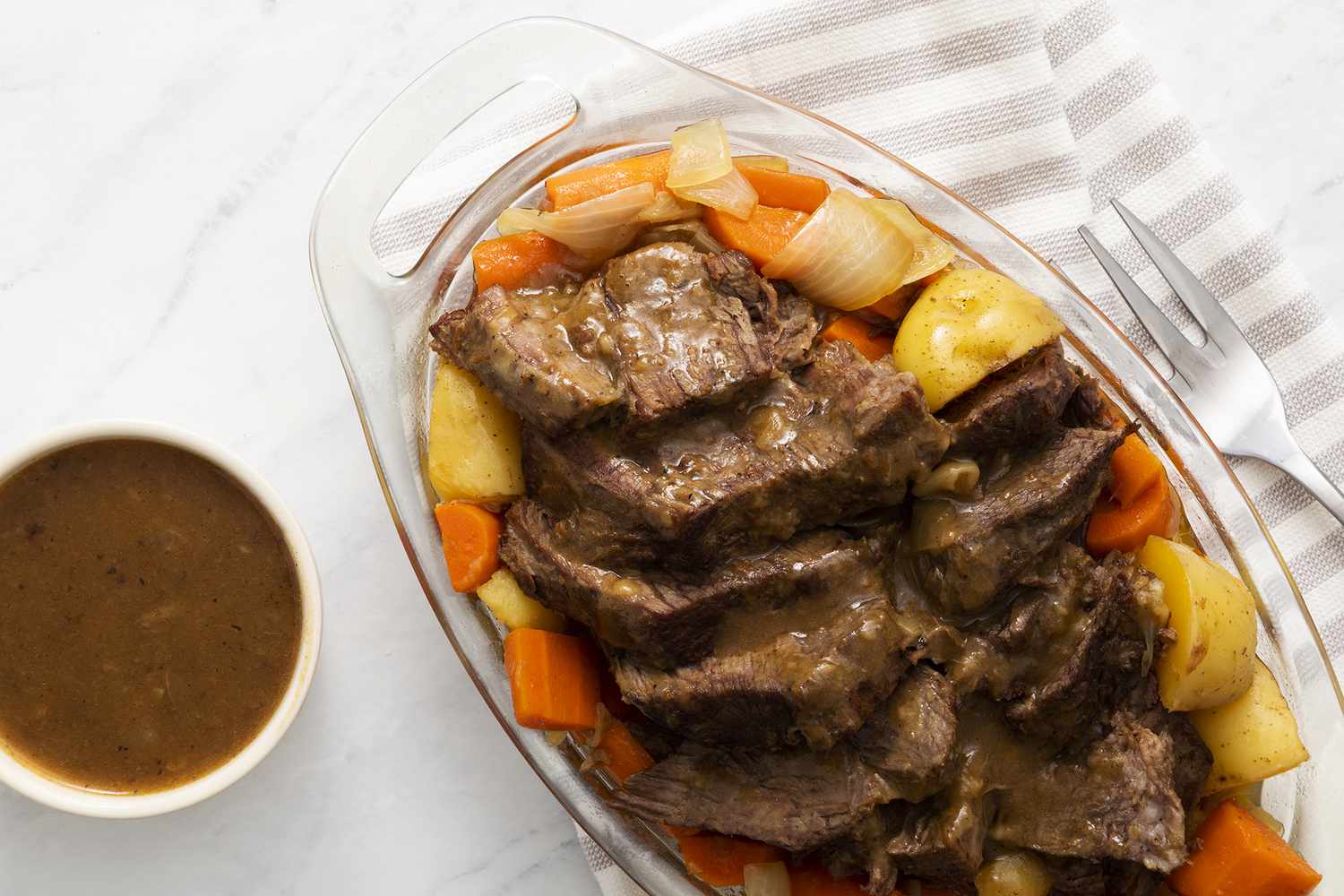 Family Pot Roast With Potatoes and Carrots with gravy on top 