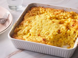 Cornbread pudding served in a white casserole dish. 