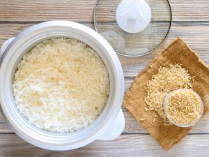 Rice in a rice cooker and uncooked rice