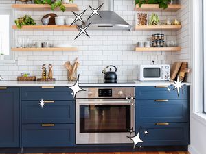 A photo of a clean, bright kitchen with floating shelves and subway tile