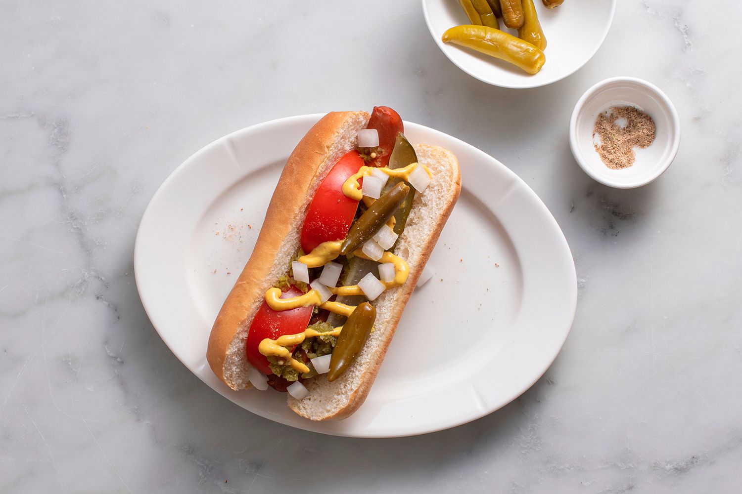 A Chicago hot dog topped with sport peppers and celery salt