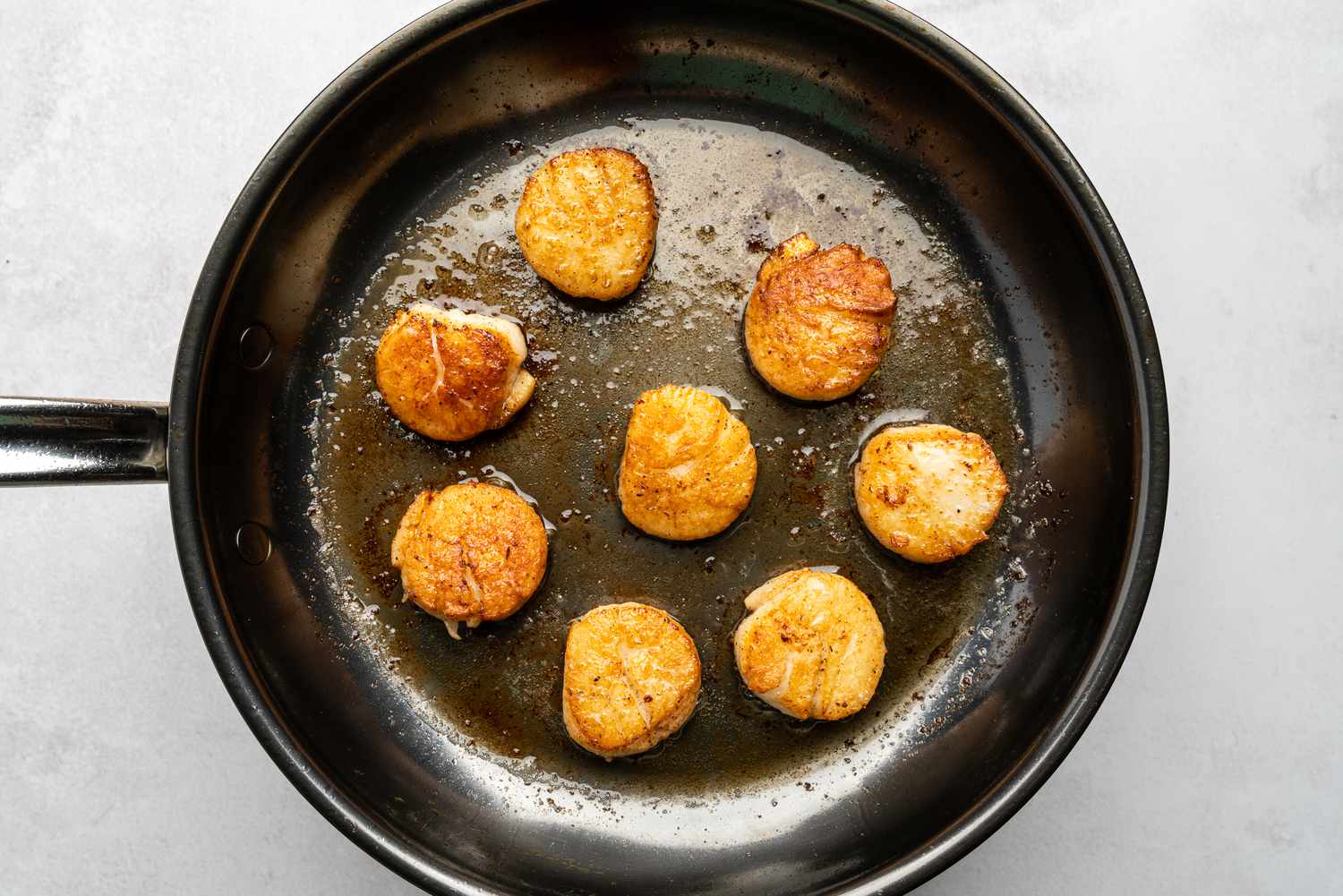 scallops cooking in a pan 