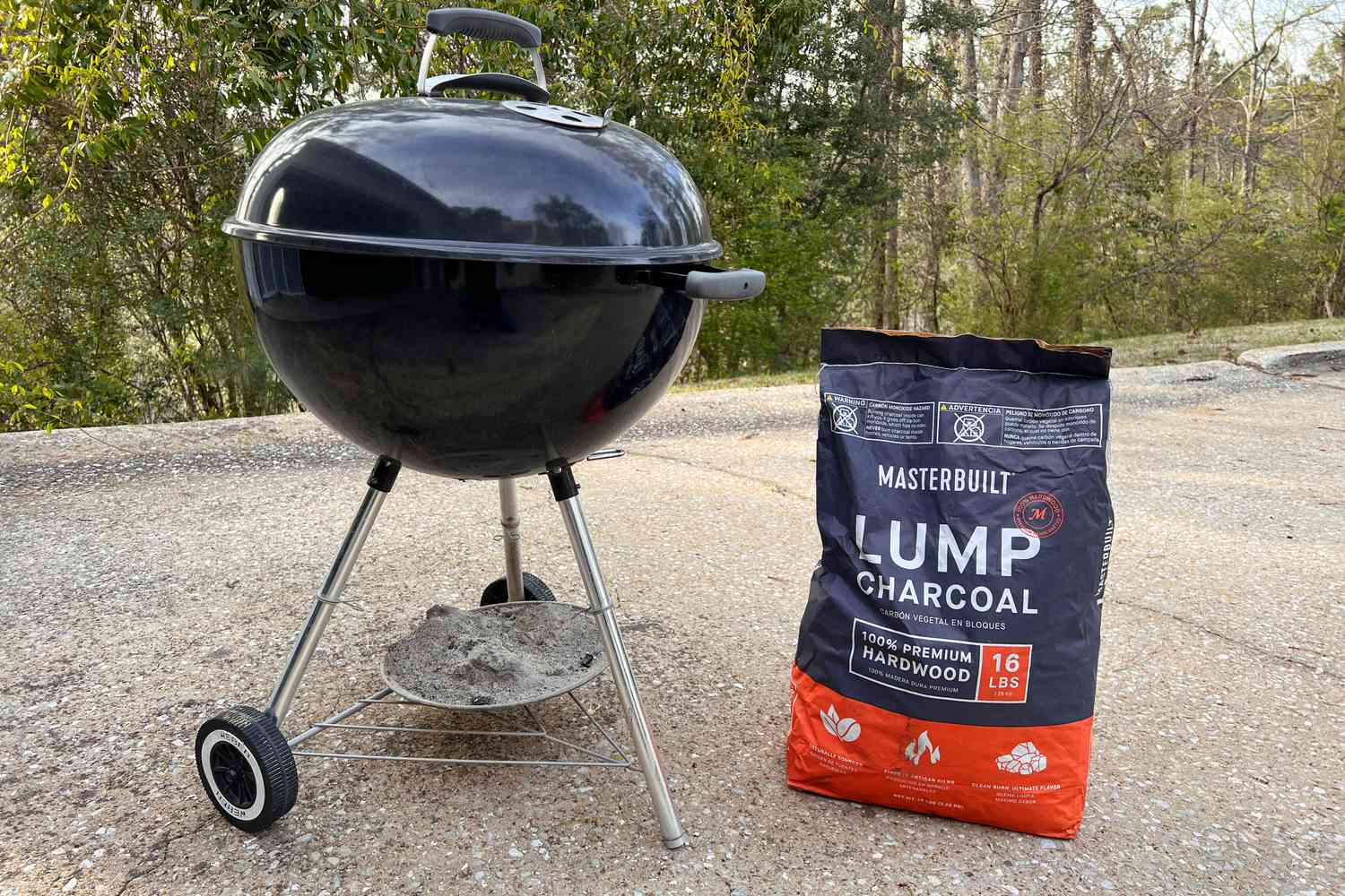 Masterbuilt Lump Charcoal bag next to a grill 