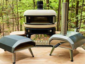 Assortment of best pizza ovens displayed on table outside