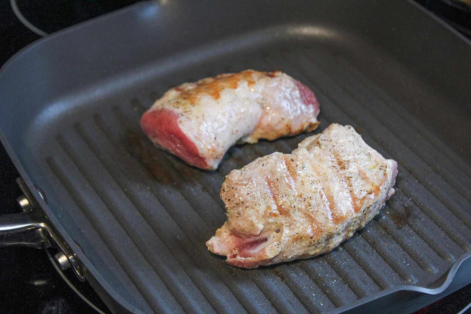 Two chicken breasts being cooked in the Anolon Advanced Nonstick Square Grill Pan