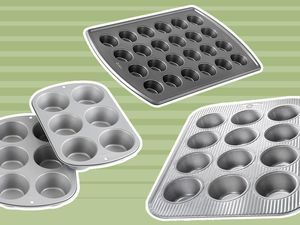 A variety of muffin pans on a green background