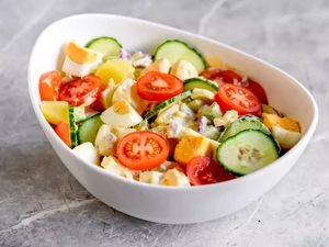 Potato salad with vegetables and eggs.