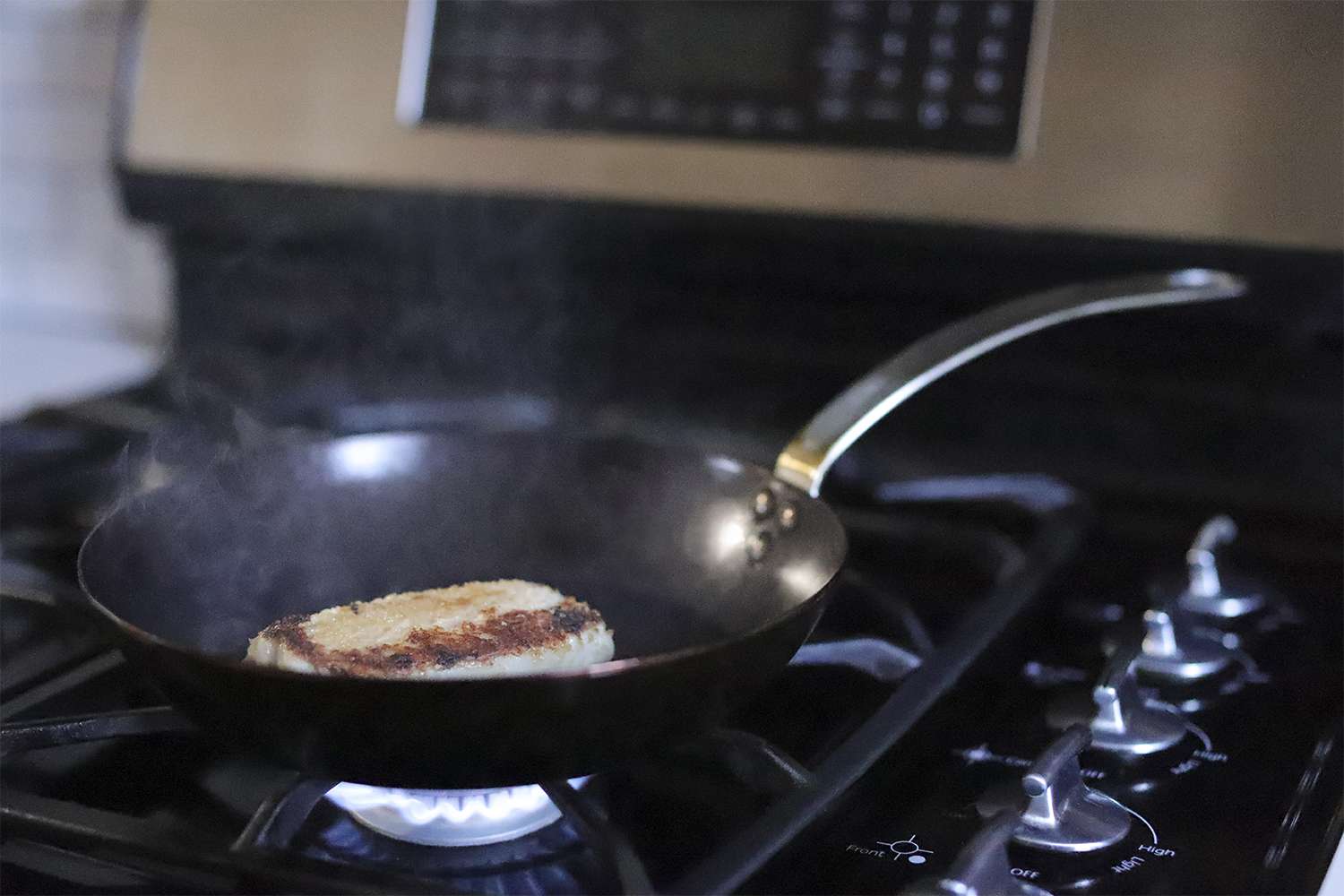 Made In Blue Carbon Steel Frying Pan searing meat on the stove