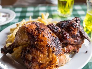 Peruvian chicken resting on a white plate 