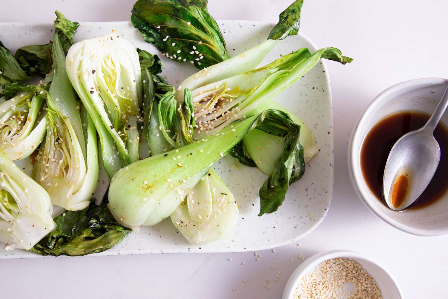 Roasted Bok Choy on a platter along with dipping sauce