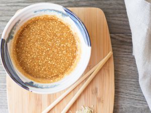 Japanese sesame salad dressing in a bowl with chopsticks nearby