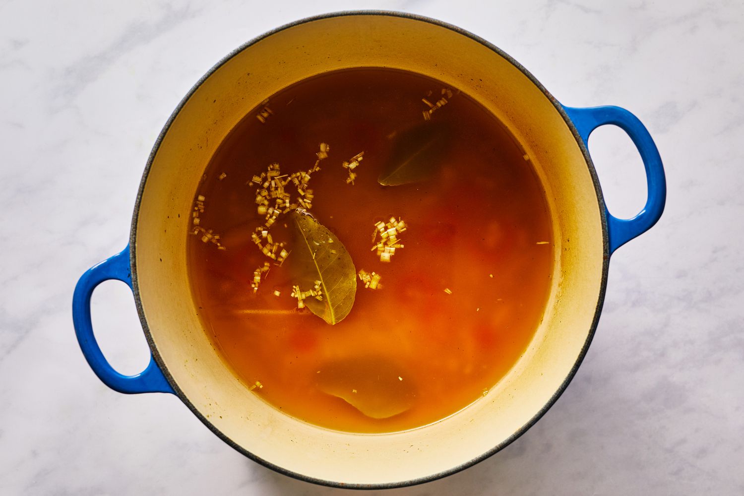 Stock in a pot with lemongrass and lime leaf