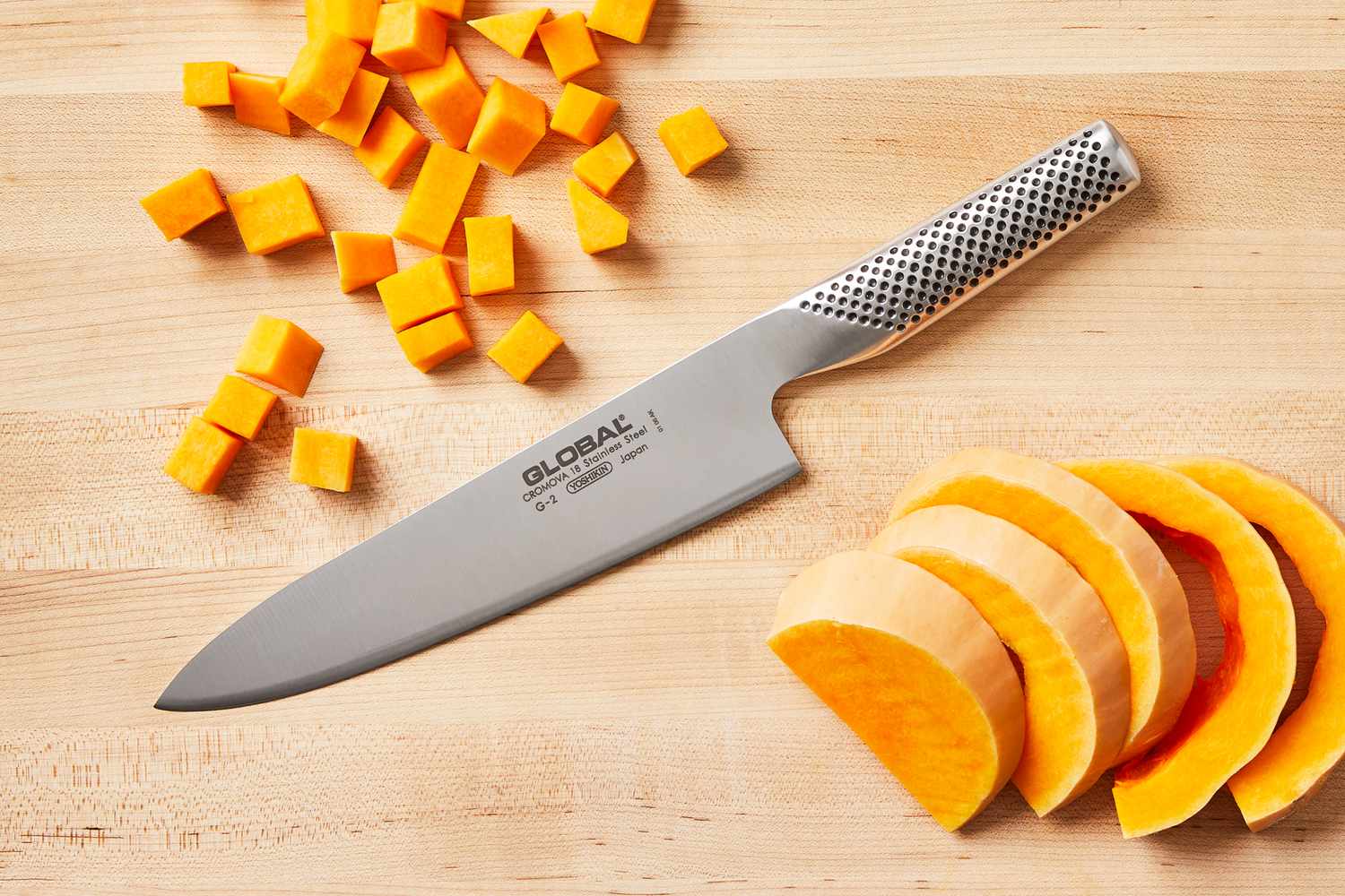 Global 8-Inch Chef's Knife on a wooden cutting board with sliced and diced butternut squash