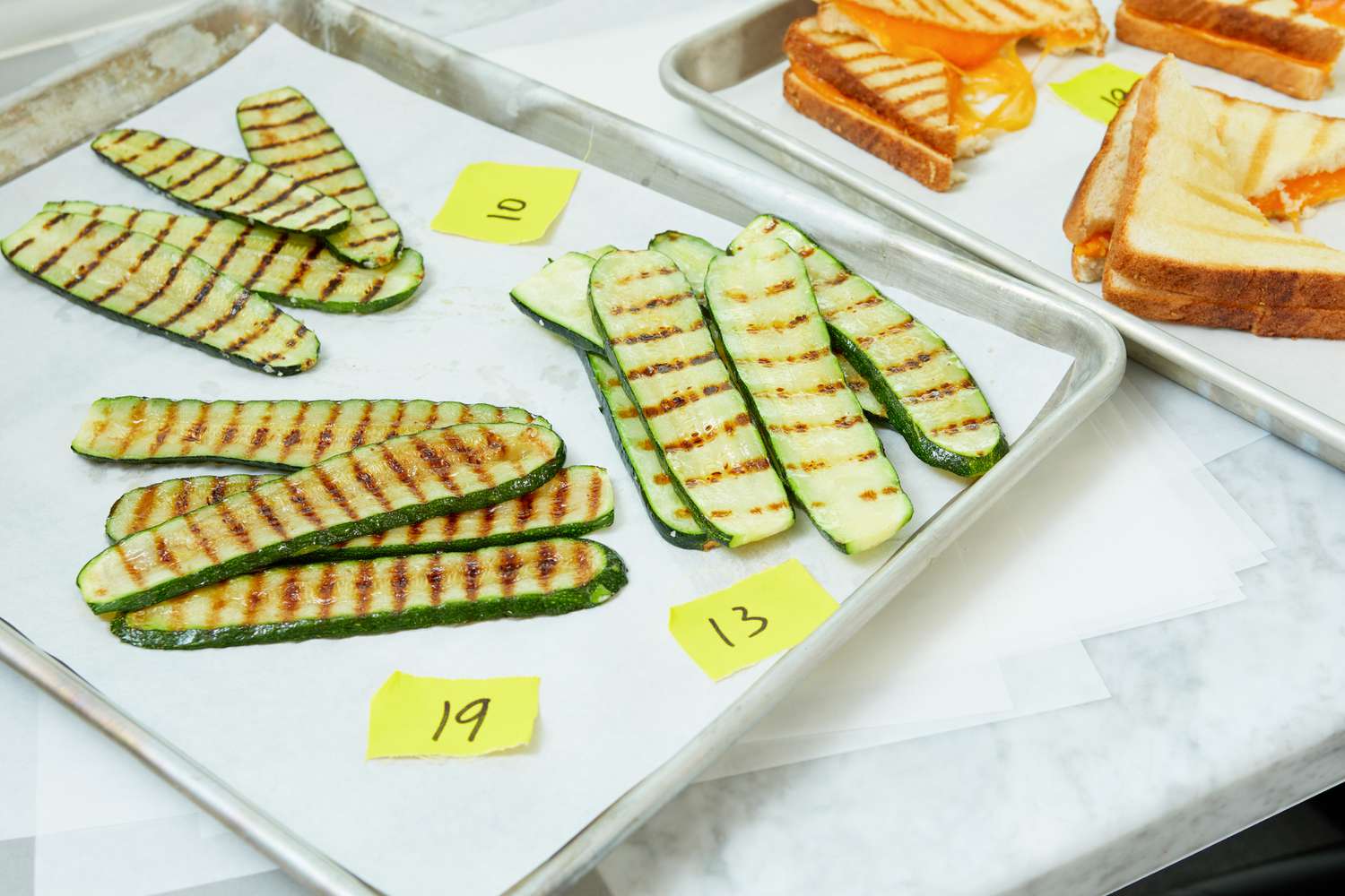 A plate of grilled zucchinis that were cooked on three different grill pans. 