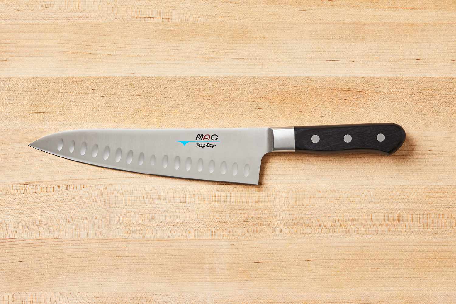 Mac Knife 8-Inch Hollow Edge Chef's Knife on a wooden cutting board